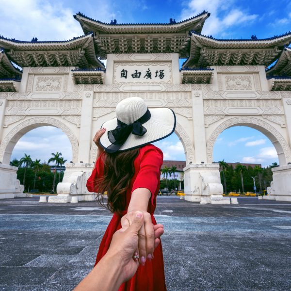 Women Tourists Holding Man's Hand And Leading Him To Chiang Kai